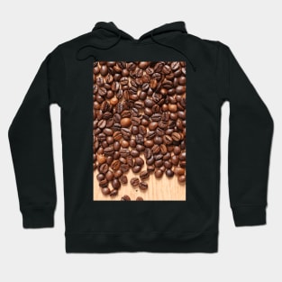 Coffee beans on wood table Hoodie